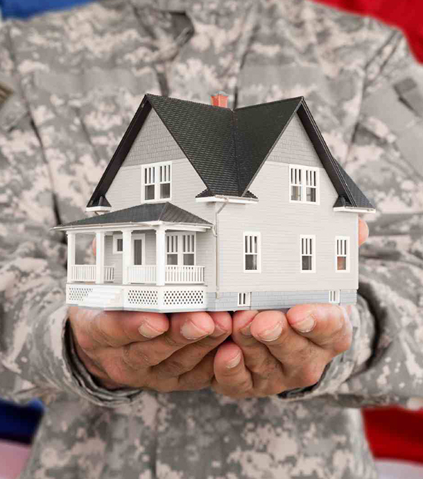 Veteran couple discussing VA mortgage options with loan officer in office