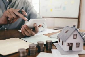 Borrower organizing pay stubs and credit reports while preparing FHA loan application