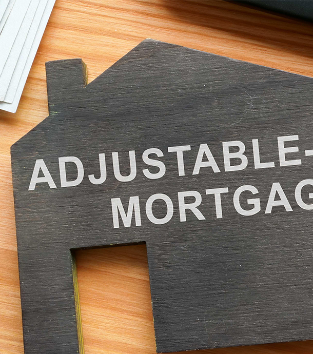 Printed mortgage rate chart being reviewed with a pen on clipboard