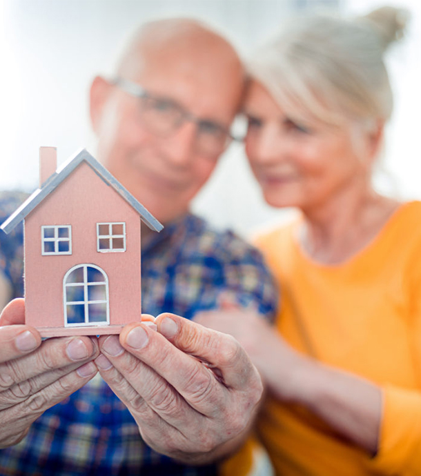 Retired homeowner discussing reverse mortgage options with loan officer in office