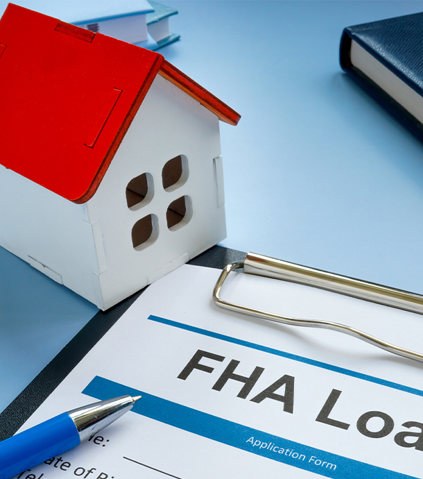 Affordable starter home with small front porch and parked compact car outside