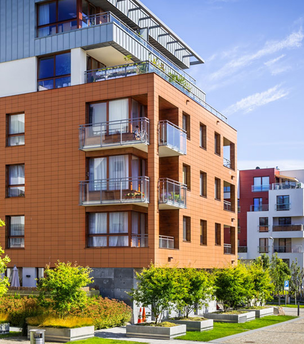 High-rise condo tower reflected in nearby office building glass windows